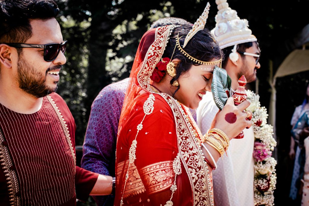 Bride and groom portrait in traditional Indian wedding attire at Radhadesh, Château de Petite Somme